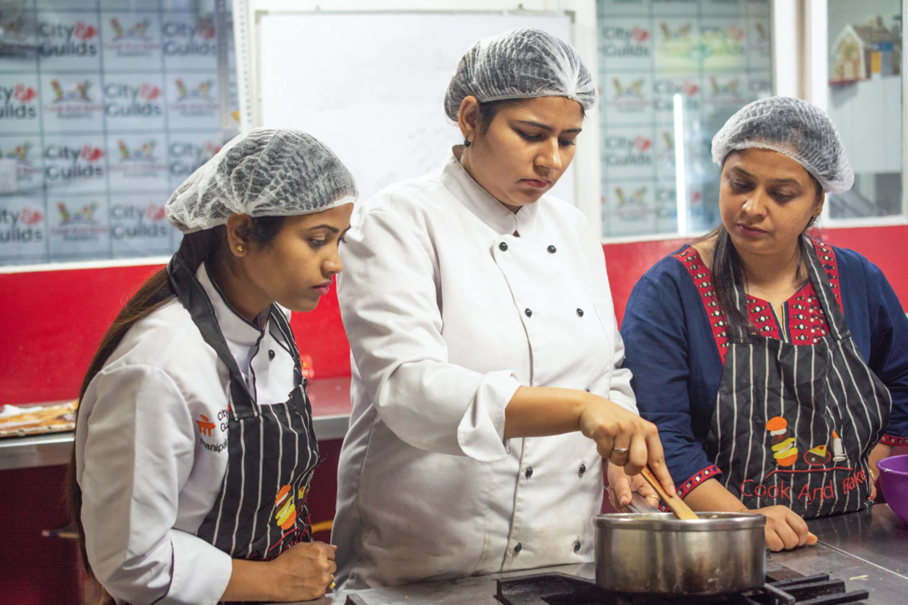Students following a chef-led cooking demonstration